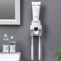 Punch-free wall hanging automatic toothpaste squeezer device toothbrush holder